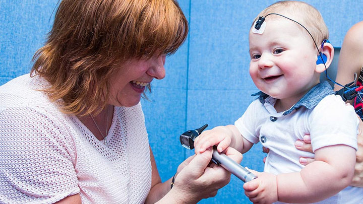 Audiologist with mother and child.