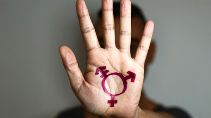 A hand with a transgender symbol drawn on it.