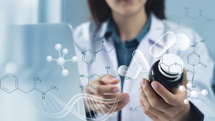 A scientist holding a bottle of medication.