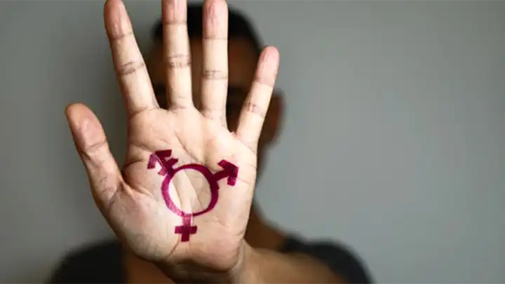 A hand with a transgender symbol drawn on it.