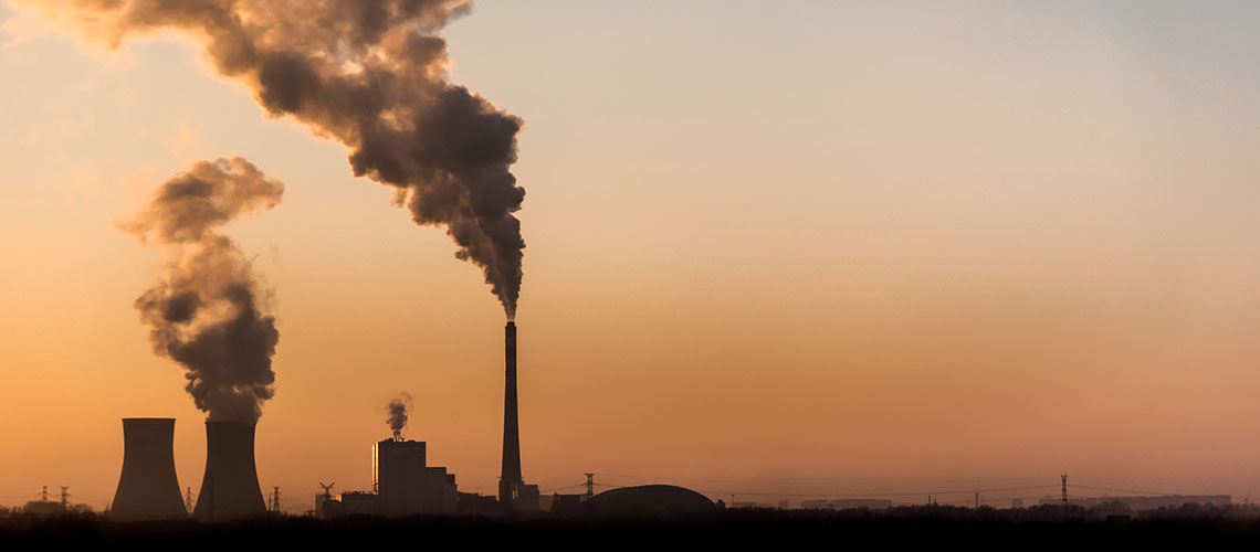 Silhouette of industrial factory smoke stack of coal power plant from chimney up on sky cause air pollution and destroy the Earth's atmosphere.