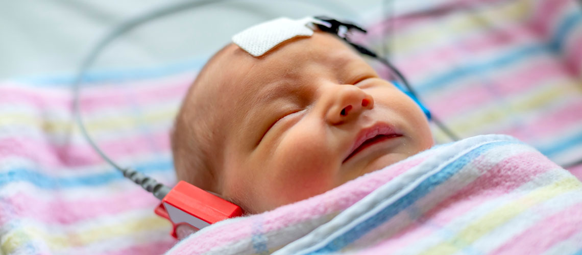 hearing test of a sleeping newborn at hospital