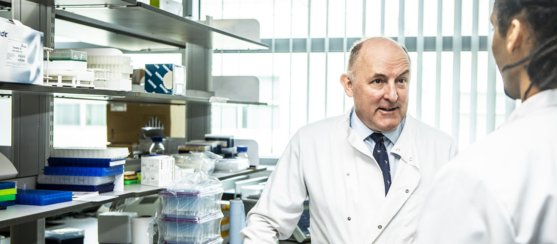 Professor Gareth Evans in discussion with a researcher