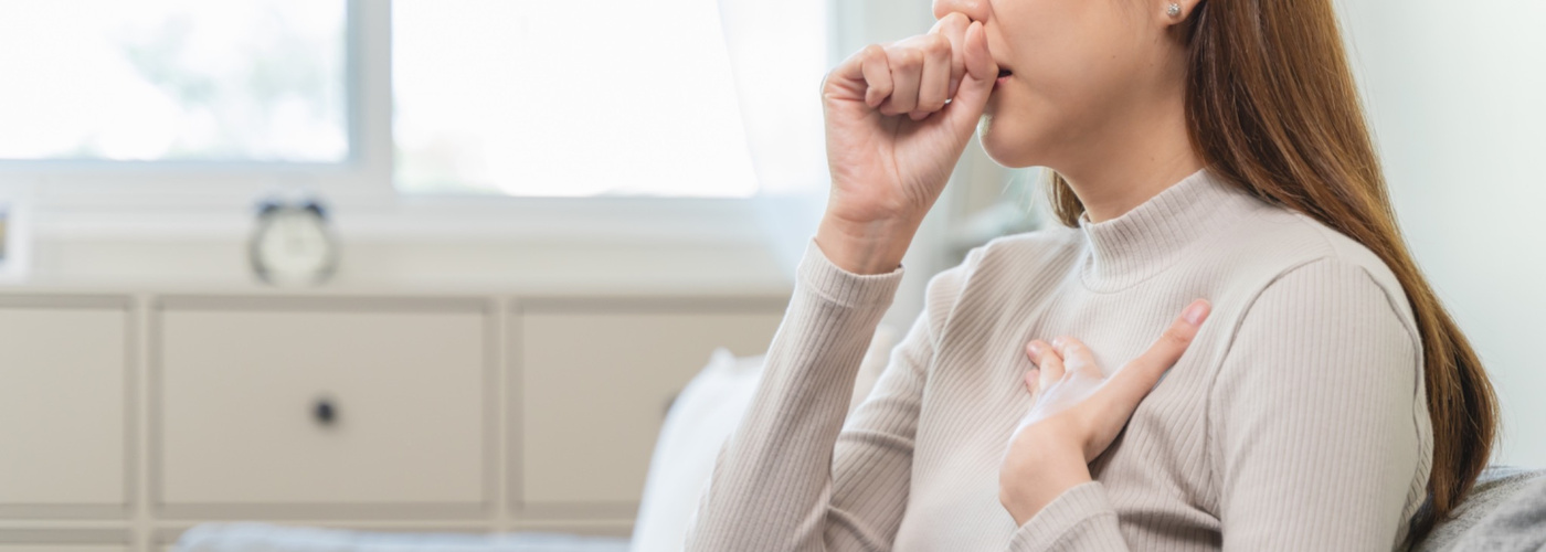 A woman coughing.