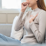 A woman coughing.