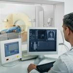 A medical professional observing a CT scan of a patient.