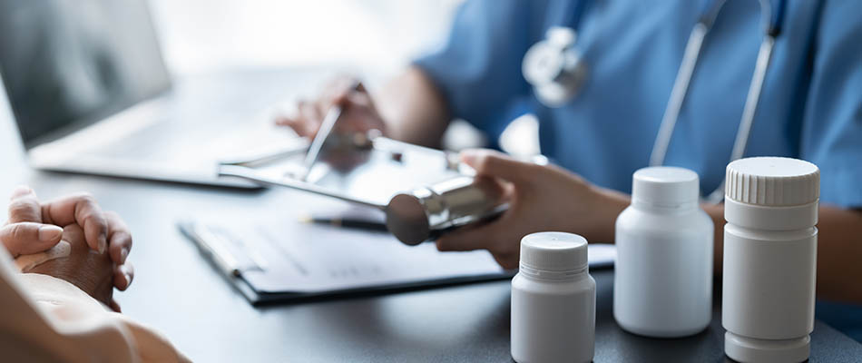 A doctor prescribing medication to a hospital patient.
