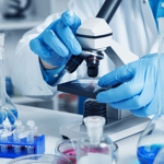 A scientist using a microscope.