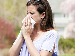 Sneezing woman with allergy