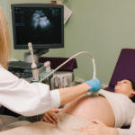A pregnant woman undergoing an ultrasound.