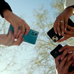 Three people holding smartphones.