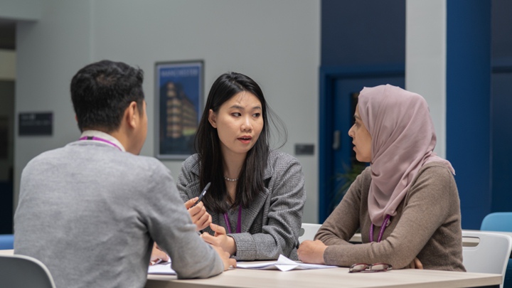 Lishan talking with other postgraduate researchers.