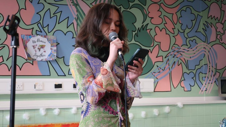 Miriam speaking into a microphone.