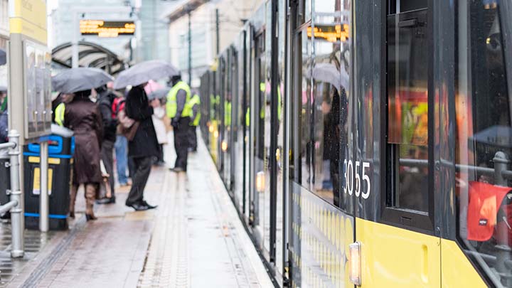 People boarding a Manchester Metrolink tram.