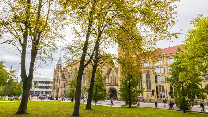 Whitworth Building through trees from Oxford Road.