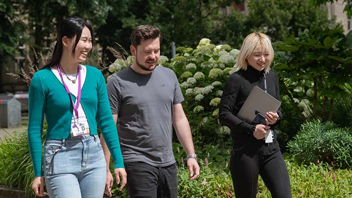 Researchers walking through campus