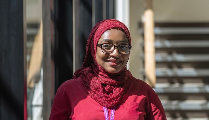 A researcher smiling looking at the camera