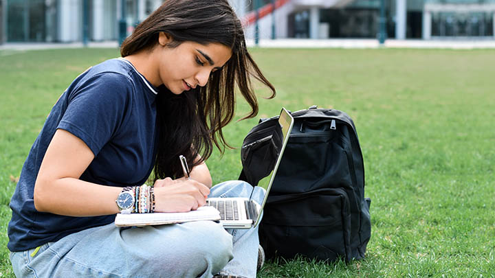 A postgraduate student accessing a website on a laptop.