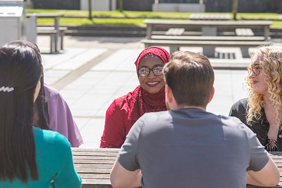 An icon showing a female doctor and NHS letters on an orange background.