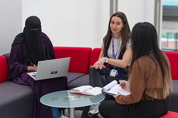 An icon of a rosette with a star on an orange background.